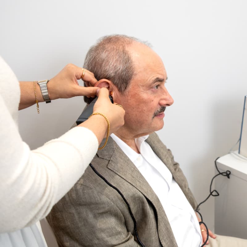 Dr Yovina completing video otoscopy with a male patient