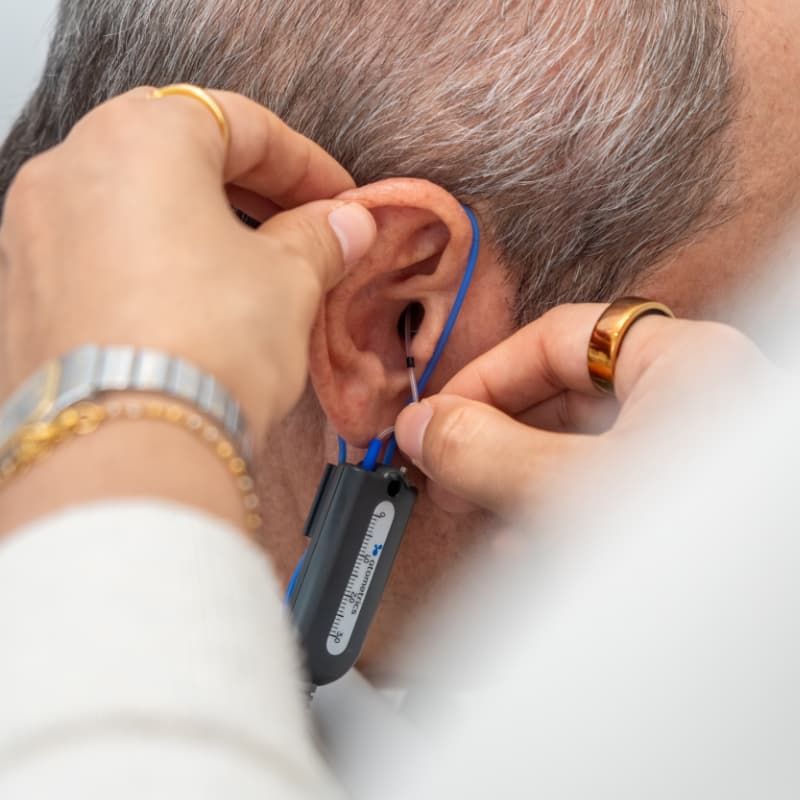 Dr Yovina completing a hearing aid hearing aid fitting with a male patient