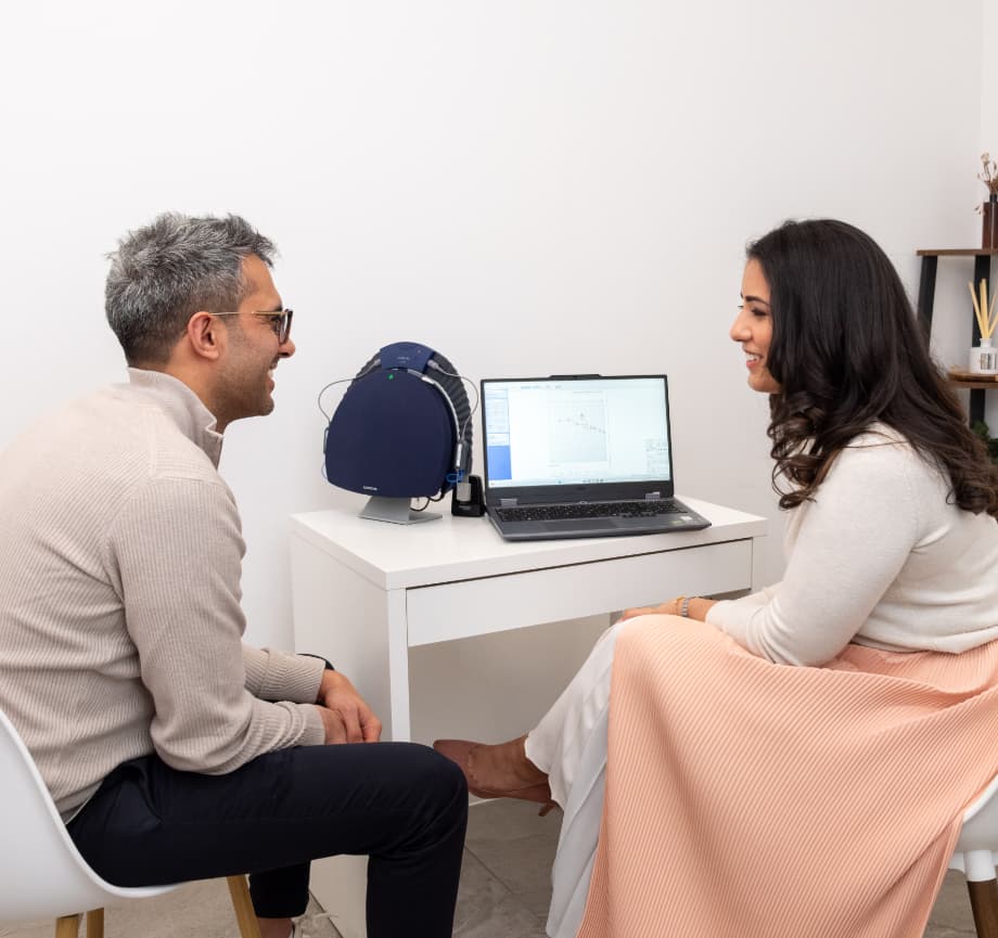 Dr Yovina completing a hearing aid consultation with a male patient